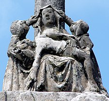 Detail from the calvary of the Chapelle Notre-Dame-de-Tronoën. The pietà on the base of the central cross. Note that the two angels are lifting Mary's veil. This was very much a trademark of the Maître de Tronoën's atelier, what art historians have called "la marque de douceur". Angels are shown lifting Mary's veil or touching Jesus' hair in a gesture of tenderness.