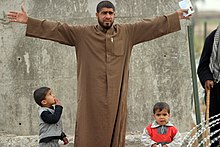 An Iraqi man comes to vote for the first elections in Iraq following the 2003 war US Navy 050130-M-7981G-024 An Iraqi man with his sons come to vote for the first ever Free Elections in Iraq.jpg