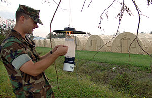 US Navy 050910-N-2653P-132 Forward Deployable Preventive Medicine Unit (FDPMU) East, removes a Light Trap provided by the Centers for Disease Control (CDC) from a tent city area on board NAS JRB New Orleans.jpg
