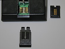 TI-59 programmable calculator with ROM software library module at right, showing gold-plated contacts. Via the modules, software for a broad spectrum of applications could be bought, even for navigational calculations at sea. WIKI TI-59 ROM Module 20161212.jpg