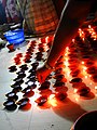 Women lighting earthen lamps on occasion of 2017 Sandhi puja at Manikanchan 28