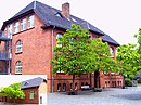 Community school with gymnasium and enclosure