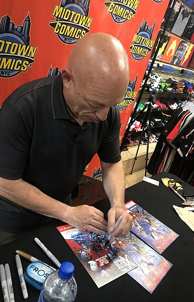 Writer Brian Michael Bendis signing a copy of the book at Midtown Comics