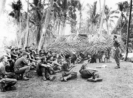 An Australian Education Officer lectures soldiers from the 6th Division, Maprik, July 1945 AWM 018819 Australian education officer lecture Maprik 1945.jpg