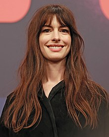A head shot of Anne Hathaway as she smiles for the camera
