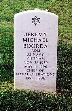 Boorda's headstone at Arlington National Cemetery located at Section 64, Lot 7101, Grid MM-17.