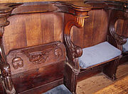 Choir stalls at Boston Stump, Lincolnshire. A seat has been lifted to reveal the misericord