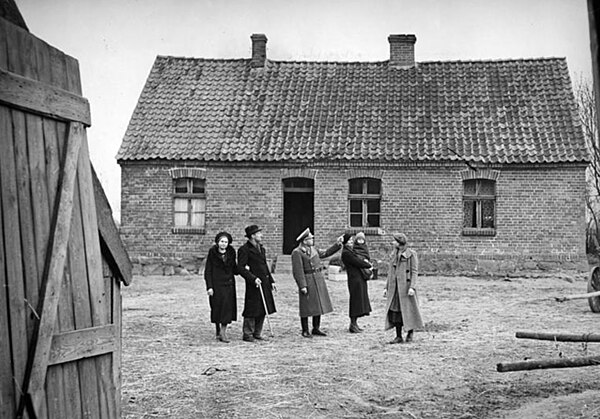 German settlers are shown around their Nazi-appropriated farmhouse in occupied Poland in November 1939 during action "Heim ins Reich"