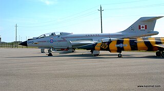 A CF-101 (background) on display at Hamilton International Airport. A CF-104 is in the foreground. Canadian Warplane Heritage Museum (7242809834).jpg