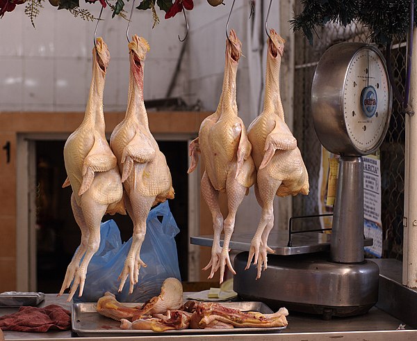 Whole chickens for sale in a public market