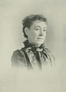 19th-century B&W portrait photo of a woman with her hair in an up-do, wearing a dark blouse.