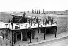 In June 1908, the 10th Company of the 13th Artillery District, NYNG (later the 245th Coast Artillery) loads a 10-inch gun at Fort Hamilton Fort Hamilton Bain LOC 01939.jpg