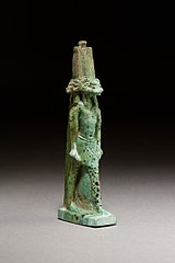 A statuette likely depicting Banebdjedet with four ram heads facing in four directions. Faience ceramic, ca 500-200 BC. Metropolitan Museum of Art