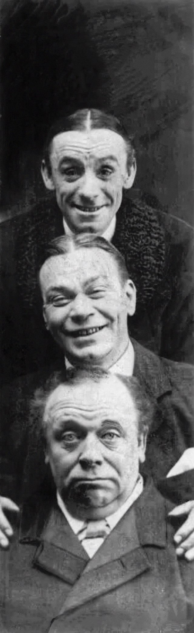 Photo of three men, with one head stacked above the other, two smiling and the bottom one gruff,