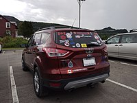 A Ford Escape with bumper stickers.