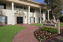 The Georgetown building offers a great example of the Southern Colonial style of architecture in southern California, with a wide setback covered with grass, cut by a running brick walkway leading to wide, crown-molded double doors. R angle Front & Sign of Building.jpg