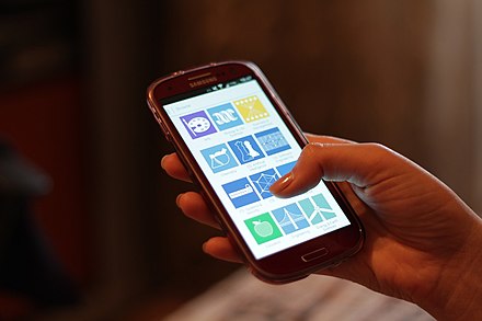 A person using a Samsung Galaxy S3 smartphone.