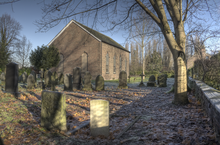 A plain brick church with tall Georgian-style windows