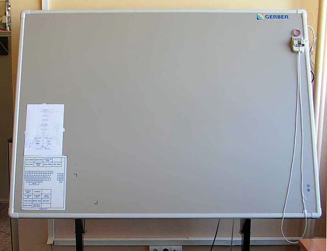 A large-format graphic tablet by manufacturer Summagraphics (OEM'd to Gerber): The puck's external copper coil can be clearly seen.