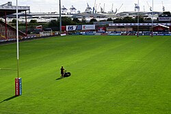 The club groundskeeper at work cutting grass on the pitch at Sewell Group Craven Park, Kingston upon Hull.