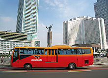 TransJakarta crossing the Selamat Datang Monument