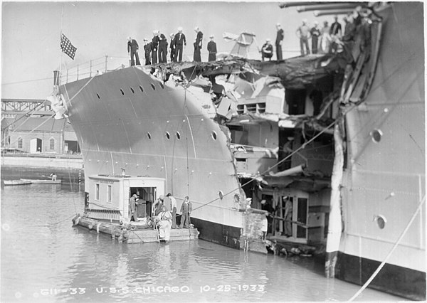 The damaged USS Chicago with Mare Island's diving barge alongside at Mare Island Navy Yard on 25 October 1933 after her collision with the British fre