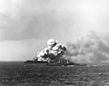 USS Princeton (CVL-23) afire at about 1004 hours on 24 October 1944, soon after she was hit by a Japanese bomb during operations off the Philippines. This view shows smoke rising from the ship's second large explosion, as USS Reno (CL-96) steams by in the foreground. Photographed from USS South Dakota (BB-57)