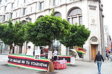 Protesters exercise freedom of speech to hold a vigil in front of the Zimbabwean Embassy in London, 2005. Vigil Zimbabwe Embassy London 20050604.jpg