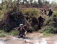 1st Infantry Division soldiers during an operation in South Vietnam in 1968 Wading Through Vietnam River.jpg