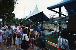 The line to get same-day tour tickets stretched a long way around in June 1994, with the Washington Monument looming in the early morning distance. WhiteHouseTourEarlyMorningLine.jpg