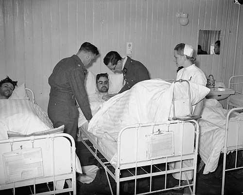 British and French medical officers and a Norwegian nurse care for British wounded in Namsos hospital, April 1940.