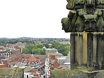 Wrexham city centre overlooked by some of the 16th century 'grotesques' of St Giles' Church Wrexham town centre overlooked by 16th century grotesques on one of the sixteen pinnacles of St Giles' Church .jpg