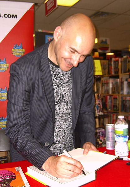 Morrison signing copies of their 2011 superhero analysis, Supergods, at Midtown Comics in Manhattan, 19 July 2011