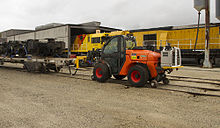 AUSA telehandler fitted with train coupler and train brake system.