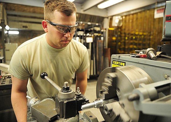 A machinist at a lathe