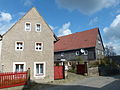 Farm with residential house (timber-frame slated), side building, courtyard wall, retaining wall of the front garden and entrance pillars to the courtyard