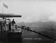 picture of large guns of USS Iowa with smoke coming out