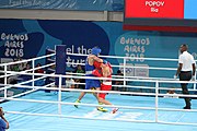 Deutsch: Boxen bei den Olympischen Jugendspielen 2018 Tag 12, 18. Oktober 2018 - Finale im Leichten Weltergewicht Jungen – Ilia Popov (Russland, rot) schlägt Talgat Shaiken (Kasachstan, blau) 4-1; Ringrichter ist James Beckles (Trinidad und Tobago). English: Boxing at the 2018 Summer Youth Olympics on 18 October 2018 – Final Light Welterweight Boys Bout - Ilia Popov (Rusia, rojo) supera a Talgat Shaiken (Kazajstán, azul) 4-1; Referee is James Beckles (Trinidad and Tobago). Español: Boxeo en los Juegos Olímpicos Juveniles de Verano de 2018 en 18 de octubre de 2018 - Chicos de peso welter ligero final: Ilia Popov (Uzbekistán, roja) le gana a Talgat Shaiken (Egipto, azul) 4-1; El árbitro es James Beckles (Trinidad y Tobago).