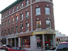 The name of the Dewey, Cheetham & Howe corporate offices (otherwise known as the headquarters of the radio show Car Talk) is visible in 2004 on the third floor window above the corner of Brattle and JFK Streets, in Harvard Square, Cambridge, Massachusetts. Car Talk Dewey, Cheetham & Howe.jpg