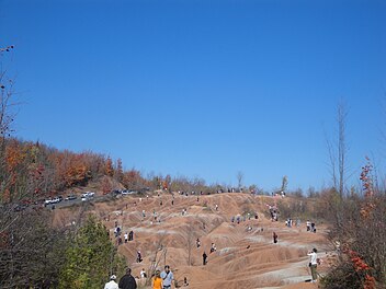 Tourists in 2010 on the slopes of the Cheltenham Badlands CheltenhamBadlands2.JPG