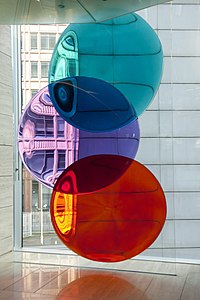 Colour Eclipse by Danny Lane. Three glass disks, with one coloured turquoise, another purple, and a third coloured red