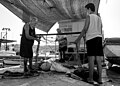 Family members of different generations join forces to have the fishing nets clean