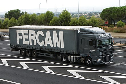 Depending on the variety of English used, this is either a truck or a lorry, and its color or colour is spelled or spelt gray or grey.