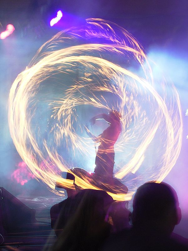 Performer with fire poi