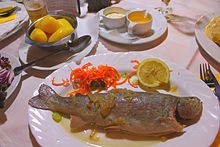 Trout blau with boiled potatoes, melted butter, creamed horseradish and salad