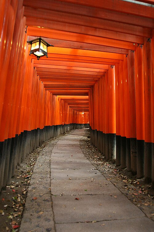 The orange gateways at the Fushimi Inari shrine in Fushimi-ku, Kyoto, used in the scene where a young Chiyo runs through them