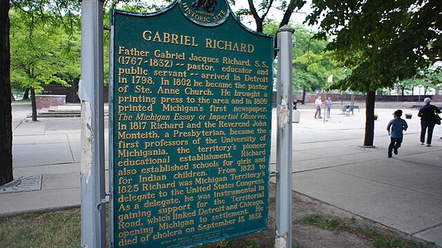 State of Michigan Historical Marker summarizing the life of Father Gabriel Richard. Located outside Basilica of Sainte Anne de Détroit