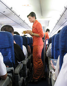 Garuda Indonesia Flight Attendants Serving Refreshment.jpg