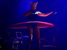 Grace Jones performing "Slave to the Rhythm", with gilded cat mask and hula-hoop, on her Hurricane Tour Gracejones-thehurricantour.jpg