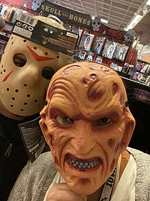 A couple trying Halloween face masks at a costume store in Iowa Halloween 2020.jpg